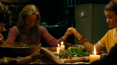 Still image from A Quiet Place showing the Abbott family praying over a meal