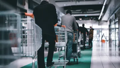 People with shopping carts standing in a checkout line